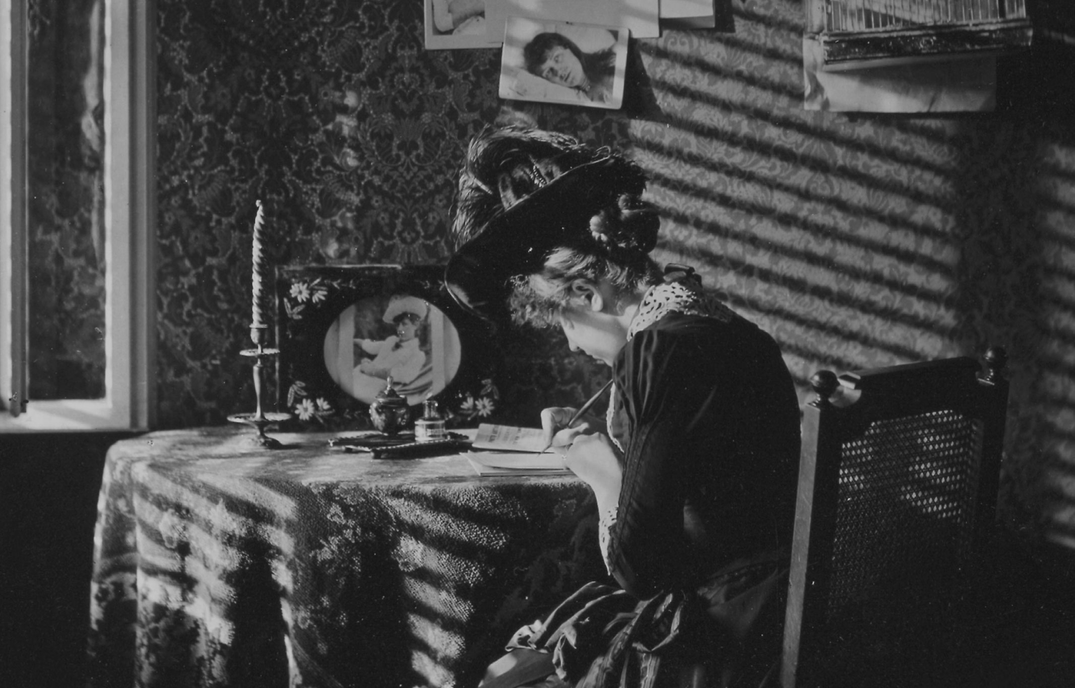 Vintage photograph of a woman writing a letter.